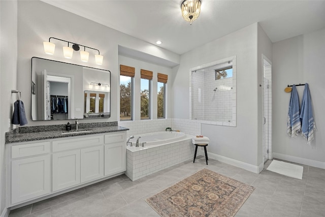 bathroom with vanity, plus walk in shower, and tile patterned flooring