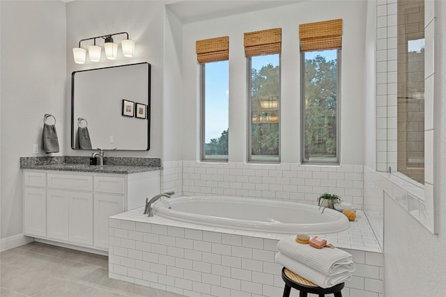 bathroom featuring vanity, tile patterned flooring, plenty of natural light, and tiled bath