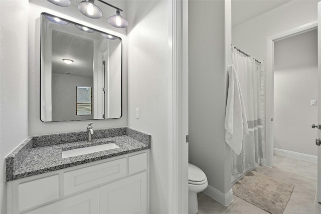 bathroom featuring walk in shower, vanity, toilet, and tile patterned floors