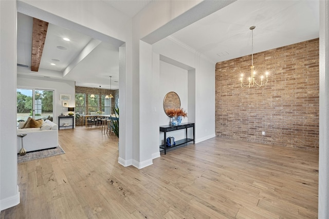 interior space featuring an inviting chandelier, brick wall, beam ceiling, and light hardwood / wood-style floors