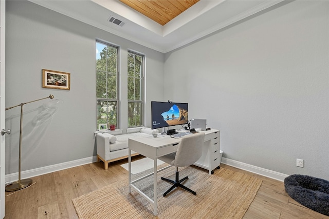 office area featuring light hardwood / wood-style floors, crown molding, wooden ceiling, and a tray ceiling