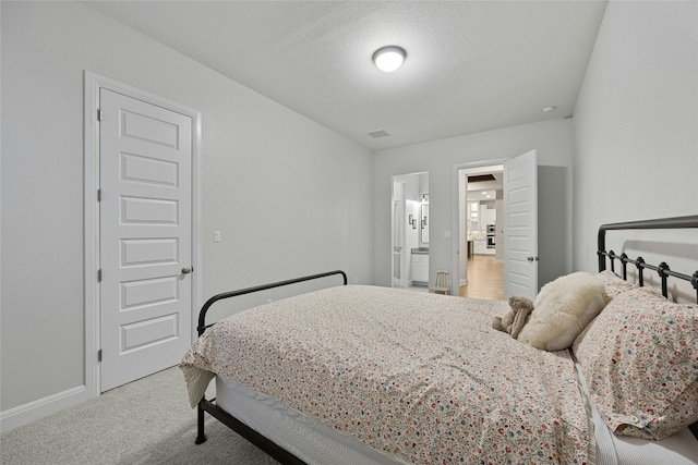 bedroom featuring carpet and a textured ceiling