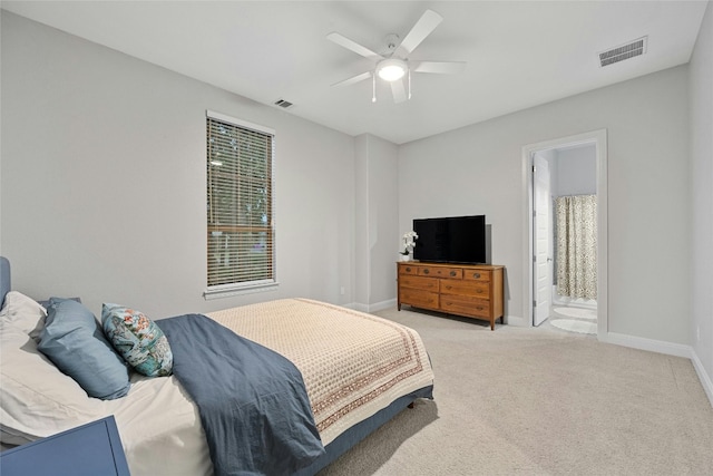 carpeted bedroom with connected bathroom and ceiling fan