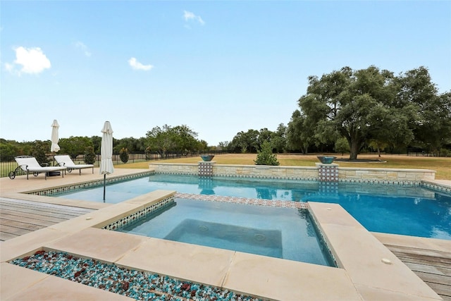 view of pool with an in ground hot tub and a patio area