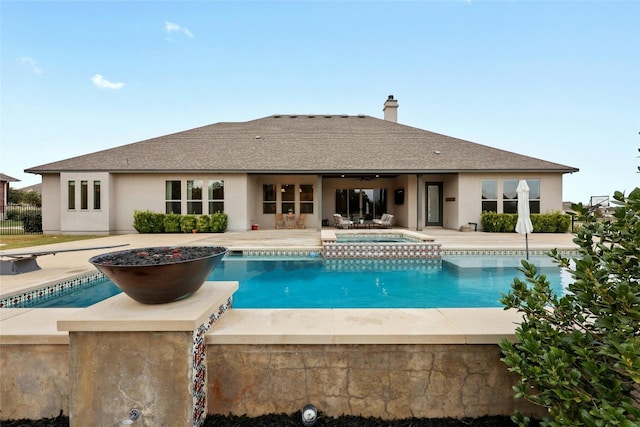 view of pool with an in ground hot tub and a patio