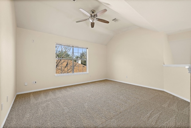 empty room with carpet floors, ceiling fan, and vaulted ceiling