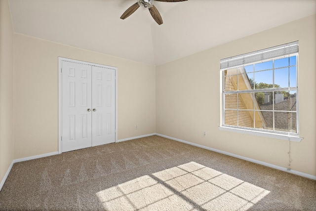 unfurnished bedroom featuring carpet floors, a closet, and ceiling fan