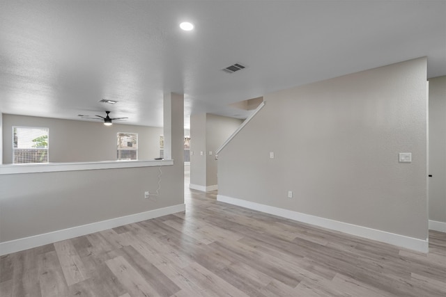 unfurnished living room with light wood-type flooring and ceiling fan