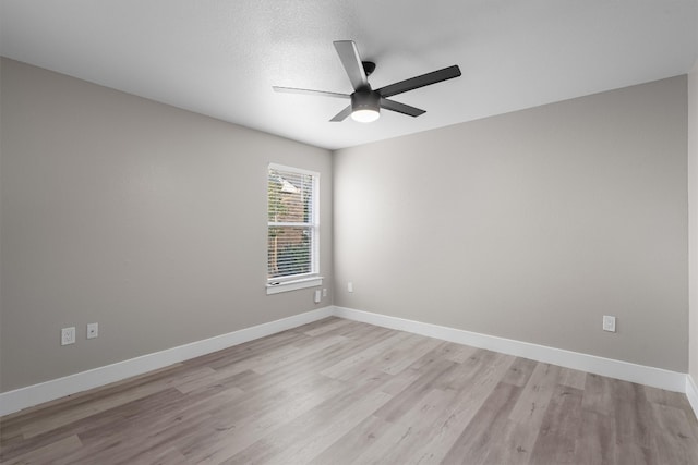 empty room featuring light hardwood / wood-style floors, a textured ceiling, and ceiling fan