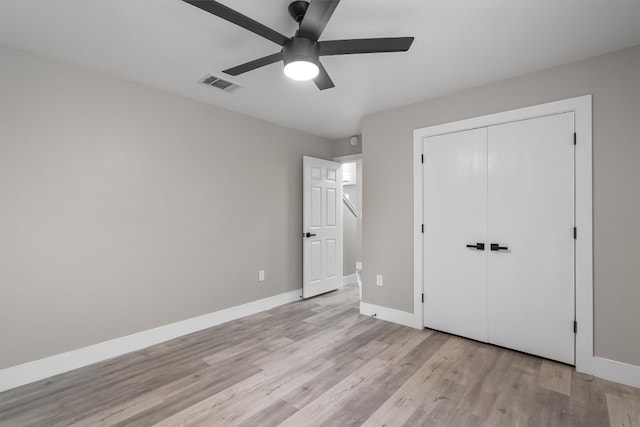 unfurnished bedroom featuring light hardwood / wood-style flooring, a closet, and ceiling fan