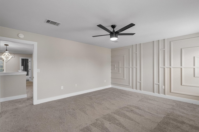 carpeted empty room featuring ceiling fan