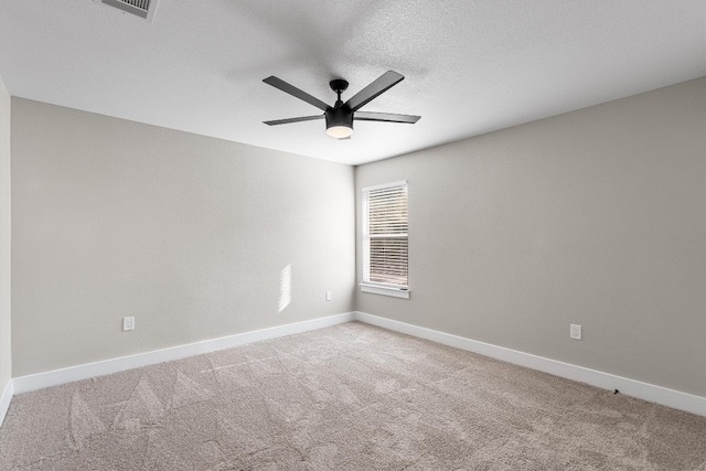 carpeted empty room featuring a textured ceiling and ceiling fan