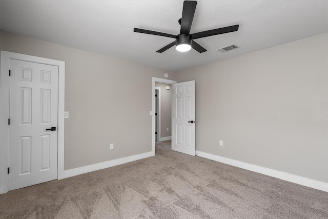 unfurnished bedroom with light carpet and ceiling fan