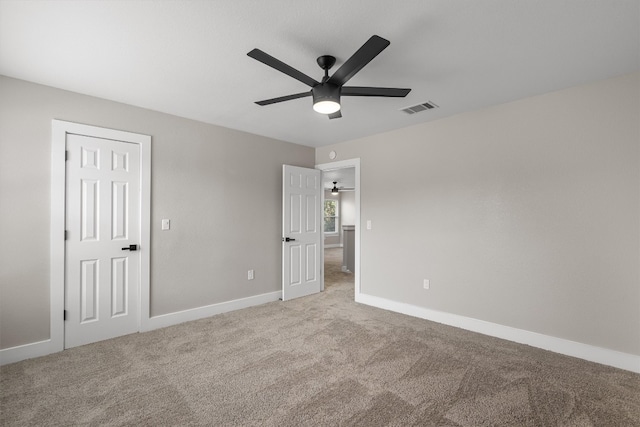 unfurnished bedroom featuring a closet, ceiling fan, and light colored carpet