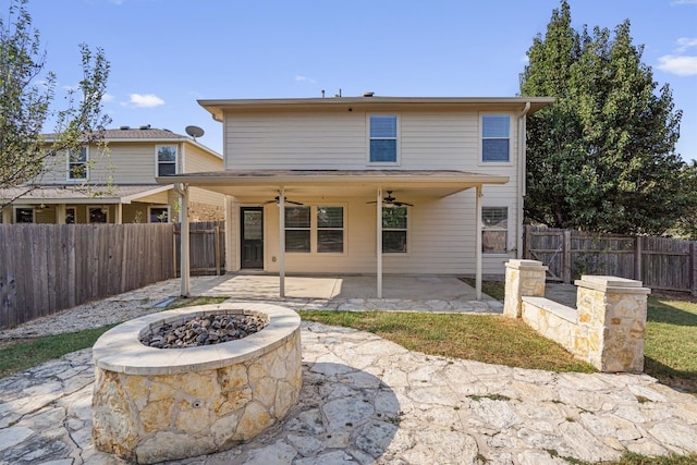 rear view of house with a patio area, a fire pit, and ceiling fan