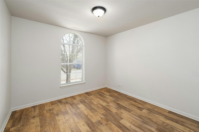 unfurnished room with hardwood / wood-style flooring