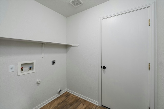 washroom featuring hookup for a gas dryer, hookup for a washing machine, dark wood-type flooring, and electric dryer hookup