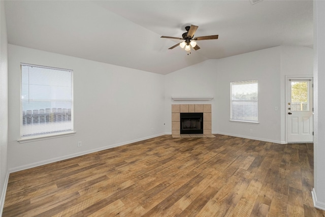 unfurnished living room with ceiling fan, wood-type flooring, vaulted ceiling, and a fireplace