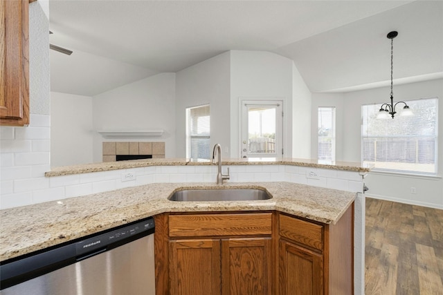 kitchen with lofted ceiling, dark hardwood / wood-style flooring, a chandelier, stainless steel dishwasher, and sink