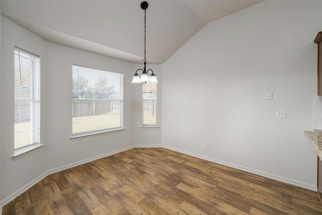 unfurnished dining area featuring lofted ceiling, dark wood-type flooring, and a wealth of natural light