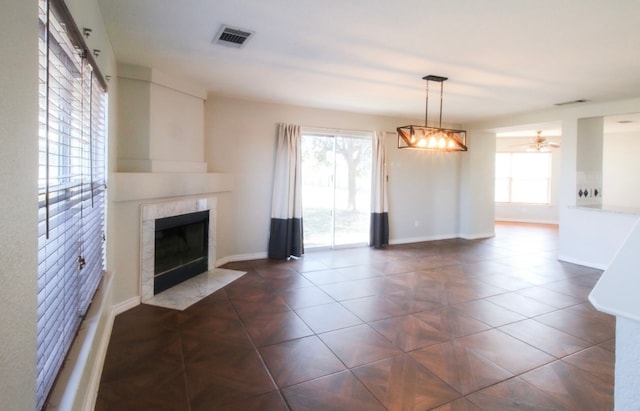 unfurnished living room with a fireplace and ceiling fan