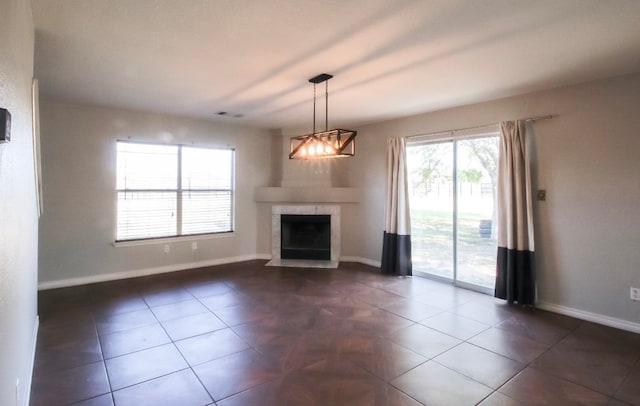 unfurnished living room featuring dark tile patterned flooring