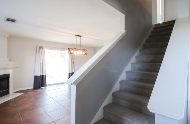 staircase featuring tile patterned floors