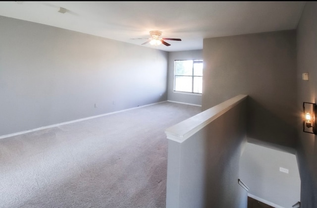 carpeted empty room with ceiling fan