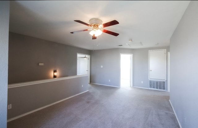 carpeted spare room with ceiling fan