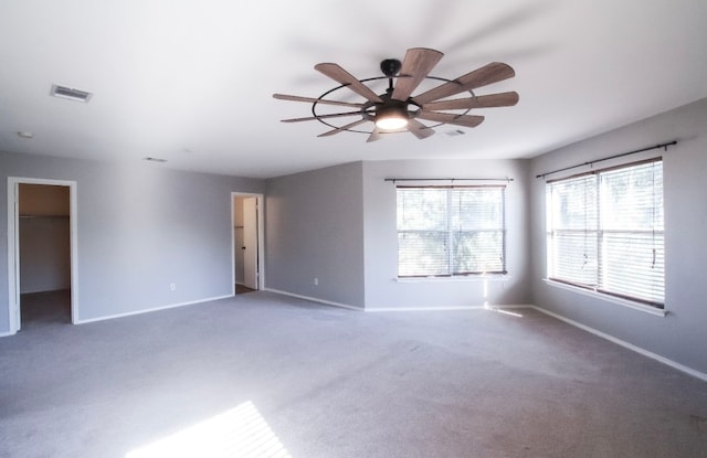 empty room featuring carpet floors and ceiling fan