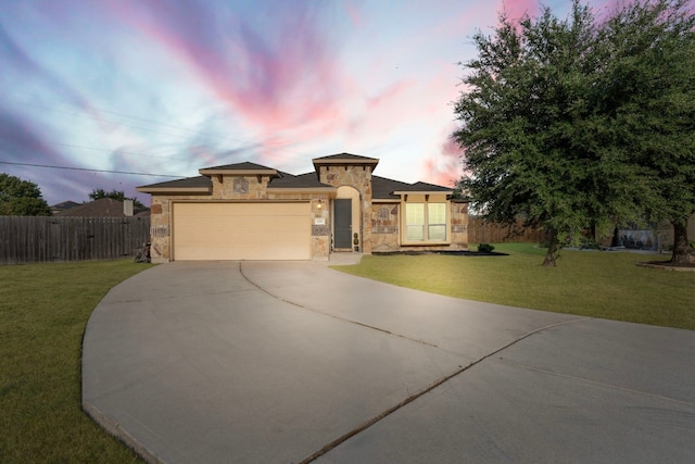 view of front of house with a lawn and a garage