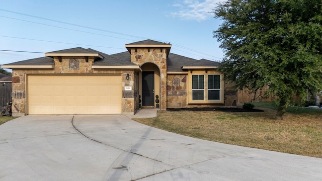 view of front of house with a front yard and a garage