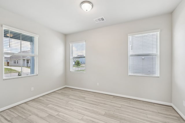 empty room with light hardwood / wood-style floors