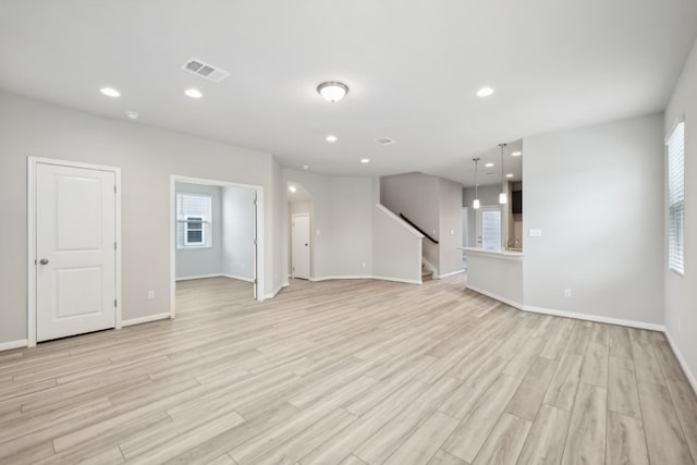 unfurnished living room with light wood-type flooring