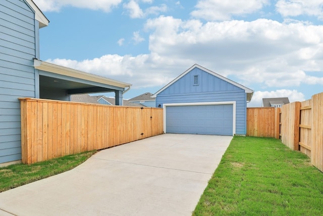 garage featuring wooden walls and a lawn