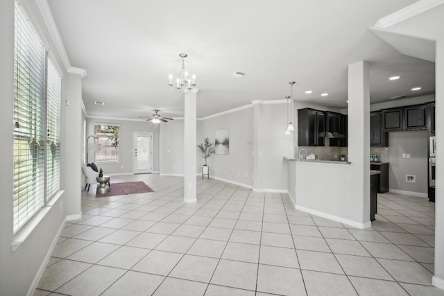 unfurnished living room featuring crown molding, light tile patterned flooring, and ceiling fan with notable chandelier