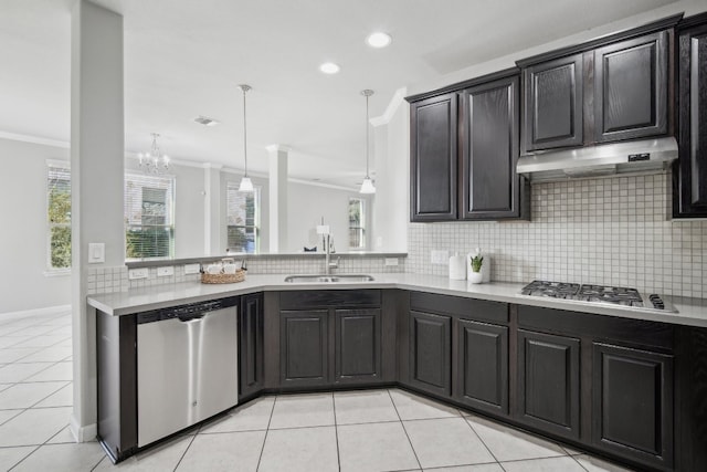 kitchen with sink, appliances with stainless steel finishes, crown molding, and tasteful backsplash