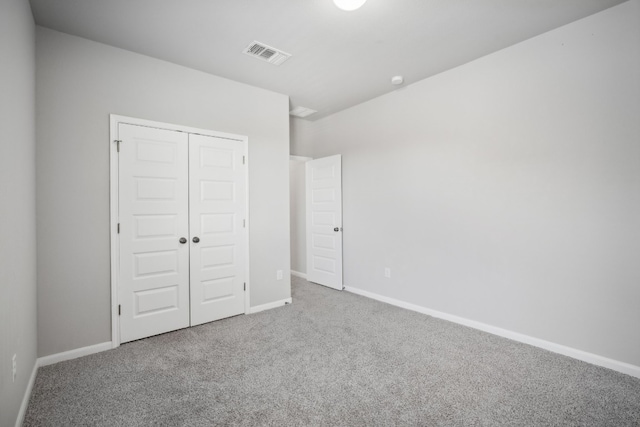 unfurnished bedroom with carpet floors and a closet