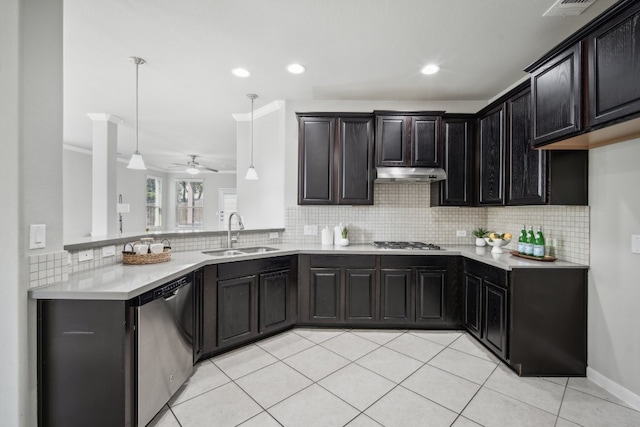 kitchen with hanging light fixtures, stainless steel appliances, backsplash, ornamental molding, and sink