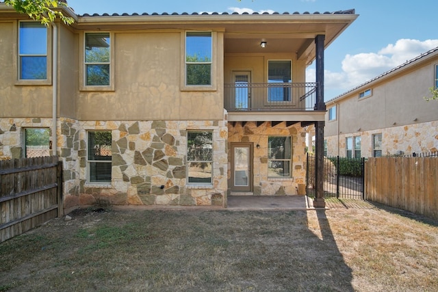 rear view of property with a patio area and a balcony