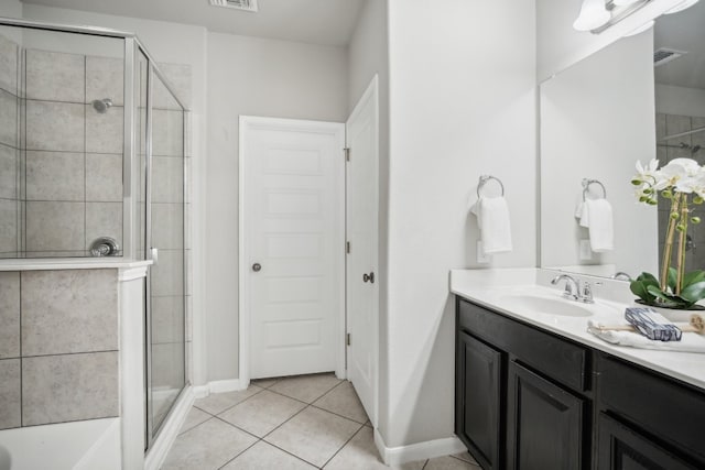 bathroom with vanity, tile patterned floors, and a shower with shower door