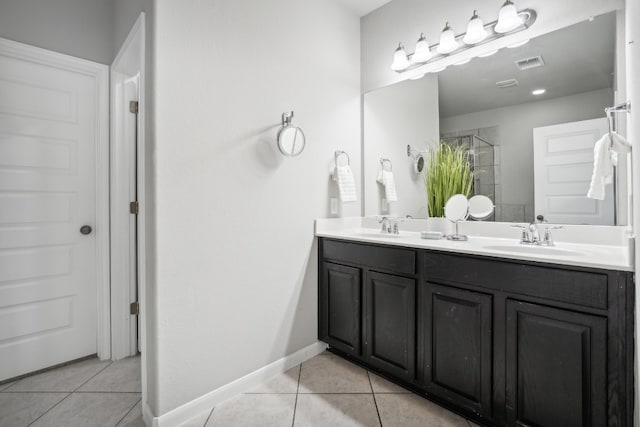 bathroom featuring vanity, tile patterned flooring, and a shower with door