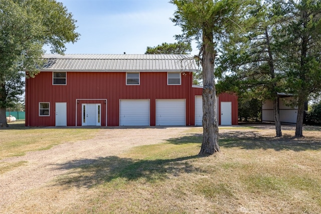 garage with wooden walls and a yard