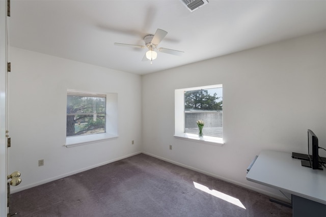 unfurnished room featuring dark colored carpet and ceiling fan