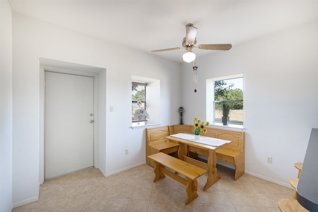 dining space with light tile patterned flooring and ceiling fan