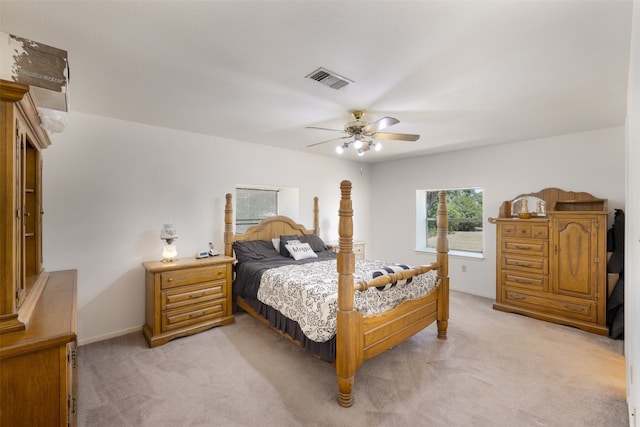 bedroom featuring light carpet and ceiling fan