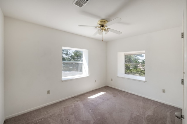 carpeted spare room featuring ceiling fan