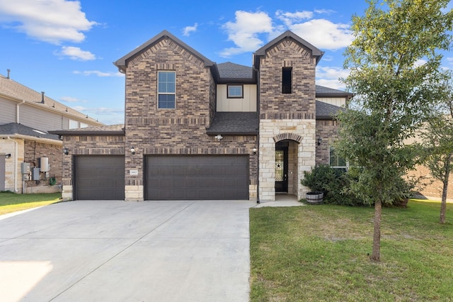 view of front of home with a garage and a front lawn