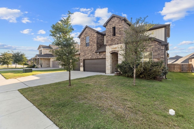 view of front of house featuring a front yard and a garage