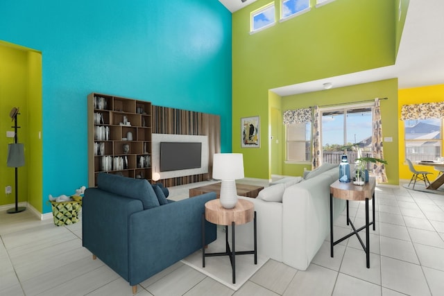 living room featuring light tile patterned flooring and a towering ceiling